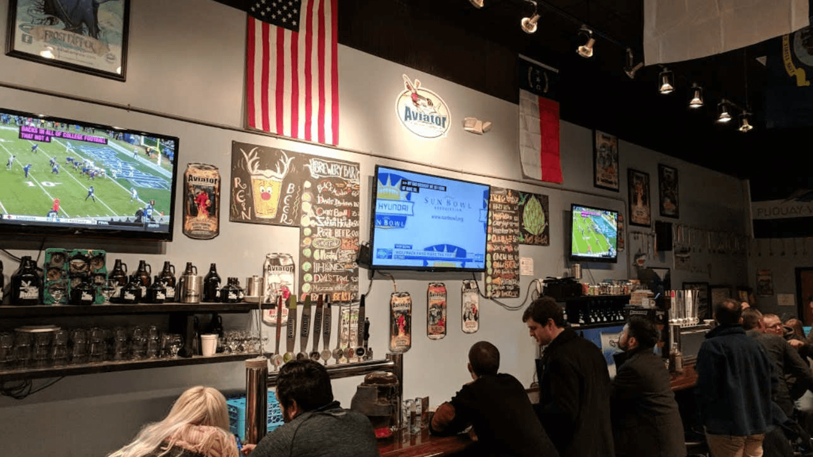 Warm aviation-inspired cocktail lounge at Aviator after dark